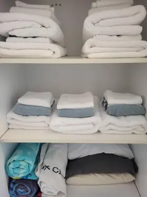 two shelves of a closet filled with towels at Nancy by the Bay Wasaga Beach in Wasaga Beach