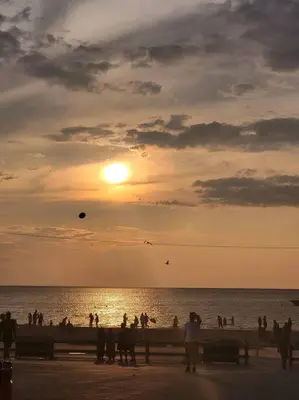 a group of people on the beach at sunset at Nancy by the Bay Wasaga Beach in Wasaga Beach