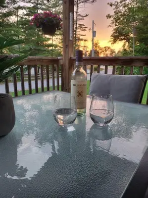 a bottle of wine and two glasses on a table at Nancy by the Bay Wasaga Beach in Wasaga Beach