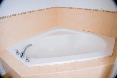 a bath tub with a faucet in a bathroom at Cozy Haven 2 bedroom Basement apartment with Treated water in London