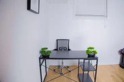 a black table with potted plants on it in a room at Cozy Haven 2 bedroom Basement apartment with Treated water in London