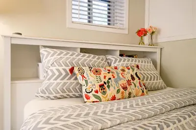 a bed with two pillows and a window at Charming Basement Suite with Private Entrance Near Subway, Koreatown & UofT in Toronto