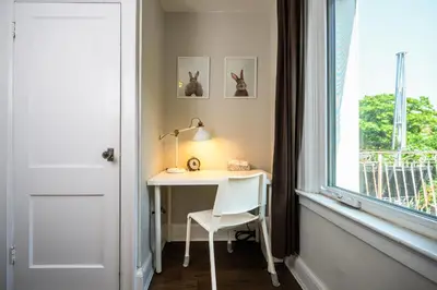 a white desk with a chair next to a window at Bright and Quiet Bedroom near Subway, Koreatown and UofT in Toronto