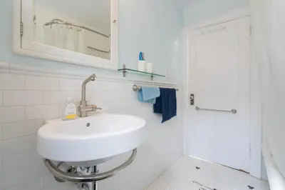 a white bathroom with a sink and a shower at Bright and Quiet Bedroom near Subway, Koreatown and UofT in Toronto