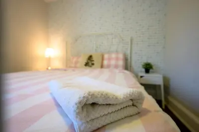 a bedroom with a bed with a white blanket at Bright and Quiet Bedroom near Subway, Koreatown and UofT in Toronto