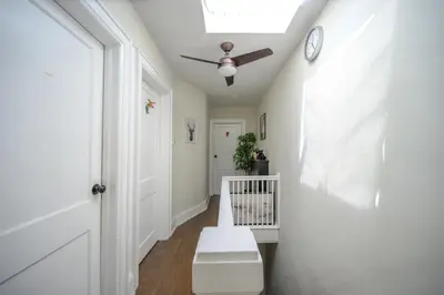 a hallway with a white door and a ceiling fan at Bright and Quiet Bedroom near Subway, Koreatown and UofT in Toronto