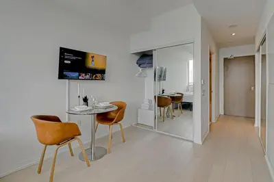 a dining room with a table and chairs in a room at The Cityscape by Instant Suites - PentHouse Unit in Toronto