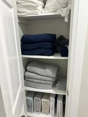 a white closet with towels and towels at Treasure Haven Near Tourism Barrie in Barrie