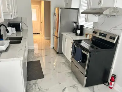 a kitchen with a stove and a refrigerator at Treasure Haven Near Tourism Barrie in Barrie