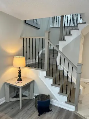 a stairway with a table and a lamp at Treasure Haven Near Tourism Barrie in Barrie