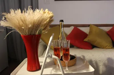 a table with two glasses and a bottle of wine at Serene Don River Nature gateway- 2BR suite, Private Patio, Free Parking in Toronto