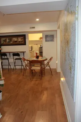 a dining room with a table and chairs and a map on the wall at Serene Don River Nature gateway- 2BR suite, Private Patio, Free Parking in Toronto