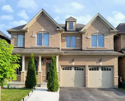a brick house with two garages at Beautiful Family Suites - Master Bedroom in Niagara Falls