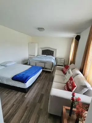 a bedroom with two beds and a couch at Beautiful Family Suites - Master Bedroom in Niagara Falls