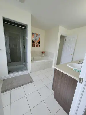 a bathroom with a sink and a shower and a tub at Beautiful Family Suites - Master Bedroom in Niagara Falls
