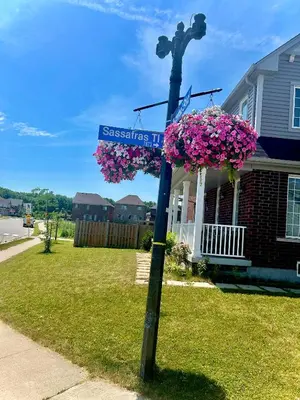a pole with a street sign in front of a house at Beautiful Family Suites - Master Bedroom in Niagara Falls