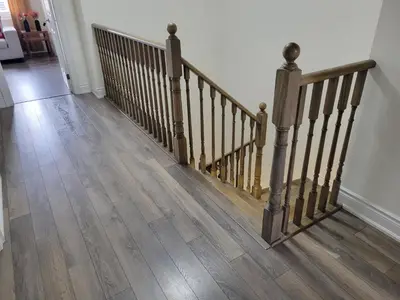 a hallway with a wooden staircase with wooden floors at Beautiful Family Suites - Master Bedroom in Niagara Falls