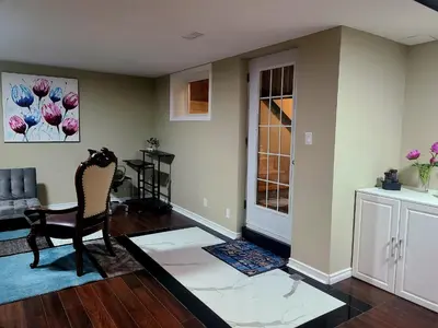 a living room with a chair and a table at Charm Heaven - Workspace, Wi-Fi, 3-Beds and Private Entrance in Pickering