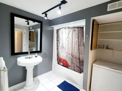 a bathroom with a sink and a mirror at Charm Heaven - Workspace, Wi-Fi, 3-Beds and Private Entrance in Pickering
