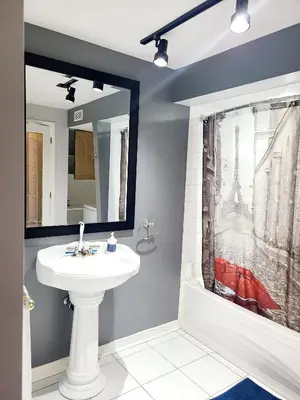 a bathroom with a sink and a mirror at Charm Heaven - Workspace, Wi-Fi, 3-Beds and Private Entrance in Pickering