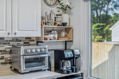 a kitchen with a stove and a microwave at Heritage 3BR Etobicoke Gem, Sherway Gardens, BBQ in Toronto