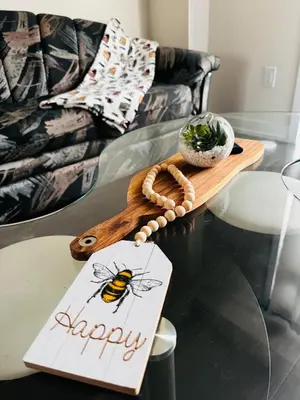 a happy sign on a glass table with a bee on it at Have whole house to yourself in Thorold