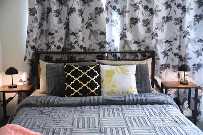 a bedroom with a bed with a floral wallpaper at Have whole house to yourself in Thorold