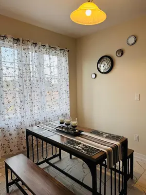 a dining room with a table and a clock on the wall at Have whole house to yourself in Thorold