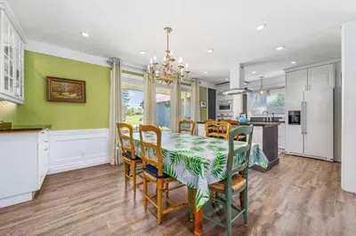 a kitchen and dining room with a table and chairs at Gate House Comfort plus own lake access, dock, 4 mins to beach in West Lake