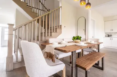 a dining room with a wooden table and chairs at Spotless 4 bed and 3 bath with Wi-Fi and 1hr to Niagara in Hamilton