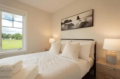 a bedroom with a white bed and a window at Spotless 4 bed and 3 bath with Wi-Fi and 1hr to Niagara in Hamilton