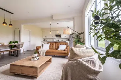 a living room with a couch and a table at Spotless 4 bed and 3 bath with Wi-Fi and 1hr to Niagara in Hamilton