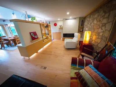a living room with a couch and a table at Riverside Retreat with Sauna & Hot Tub in Elora in Elora