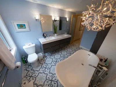 a bathroom with a sink and a toilet and a tub at Riverside Retreat with Sauna & Hot Tub in Elora in Elora