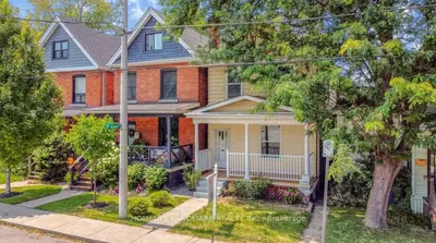 a brick house with a white front porch at H men's dormitory in Hamilton