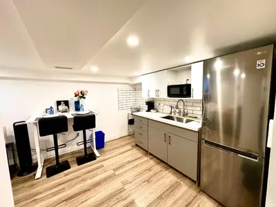 a kitchen with a stainless steel refrigerator and a sink at Pvt Studio Near Waterloo Airport & Minutes to Downtown Basement unit in Kitchener