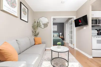 a living room with a couch and a table at Comfy Liberty Village Home 1BD Steps from King St in Toronto