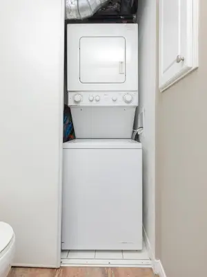 a washer and dryer in a small kitchen at Comfy Liberty Village Home 1BD Steps from King St in Toronto