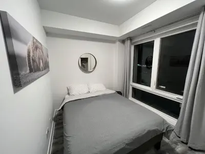 a small bedroom with a bed and a window at 2 Bed Town ideal for a fun-filled family vacation in Niagara Falls