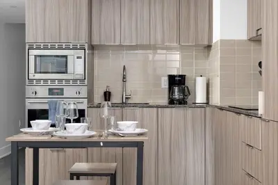 a kitchen with a table with dishes on it at Modern 1BR Condo by Yorkville w Sofa Bed Sleeps 3 in Toronto