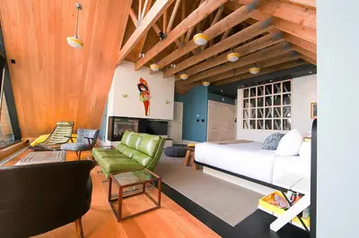 a bedroom with a bed and a living room at Drake Devonshire and Motor Inn in Wellington