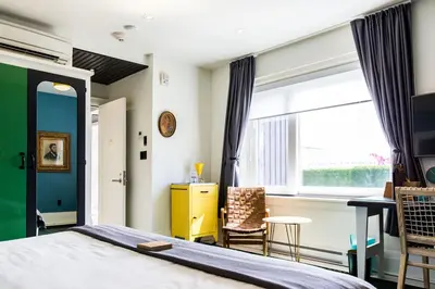a bedroom with a bed and a window and a desk at Drake Devonshire and Motor Inn in Wellington