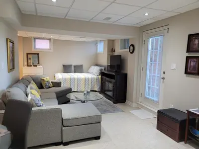 a living room with a couch and a table at Cozy and comfy Studio Apartment in Richmond Hill
