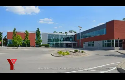 a large building with a parking lot in front of it at Rare 3 Bedroom Luxury Close to Lake in Oakville