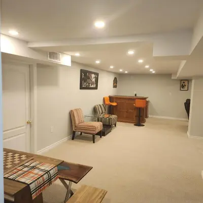a living room with two chairs and a podium at Rare 3 Bedroom Luxury Close to Lake in Oakville