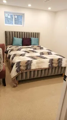 a bedroom with a large bed with a blanket at Rare 3 Bedroom Luxury Close to Lake in Oakville