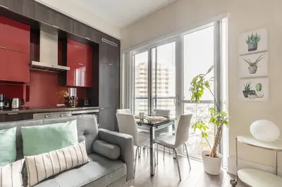 a living room with a couch and a table at Modern Suite w City Views - Downtown in Toronto