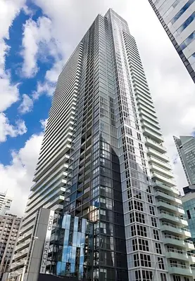 a tall building with glass windows in a city at Modern Suite w City Views - Downtown in Toronto