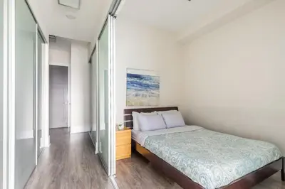 a bedroom with a bed and a glass wall at Modern Suite w City Views - Downtown in Toronto