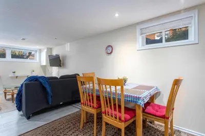 a living room with a table and chairs and a couch at Bright & Modern 1 bedroom unit! in Guelph